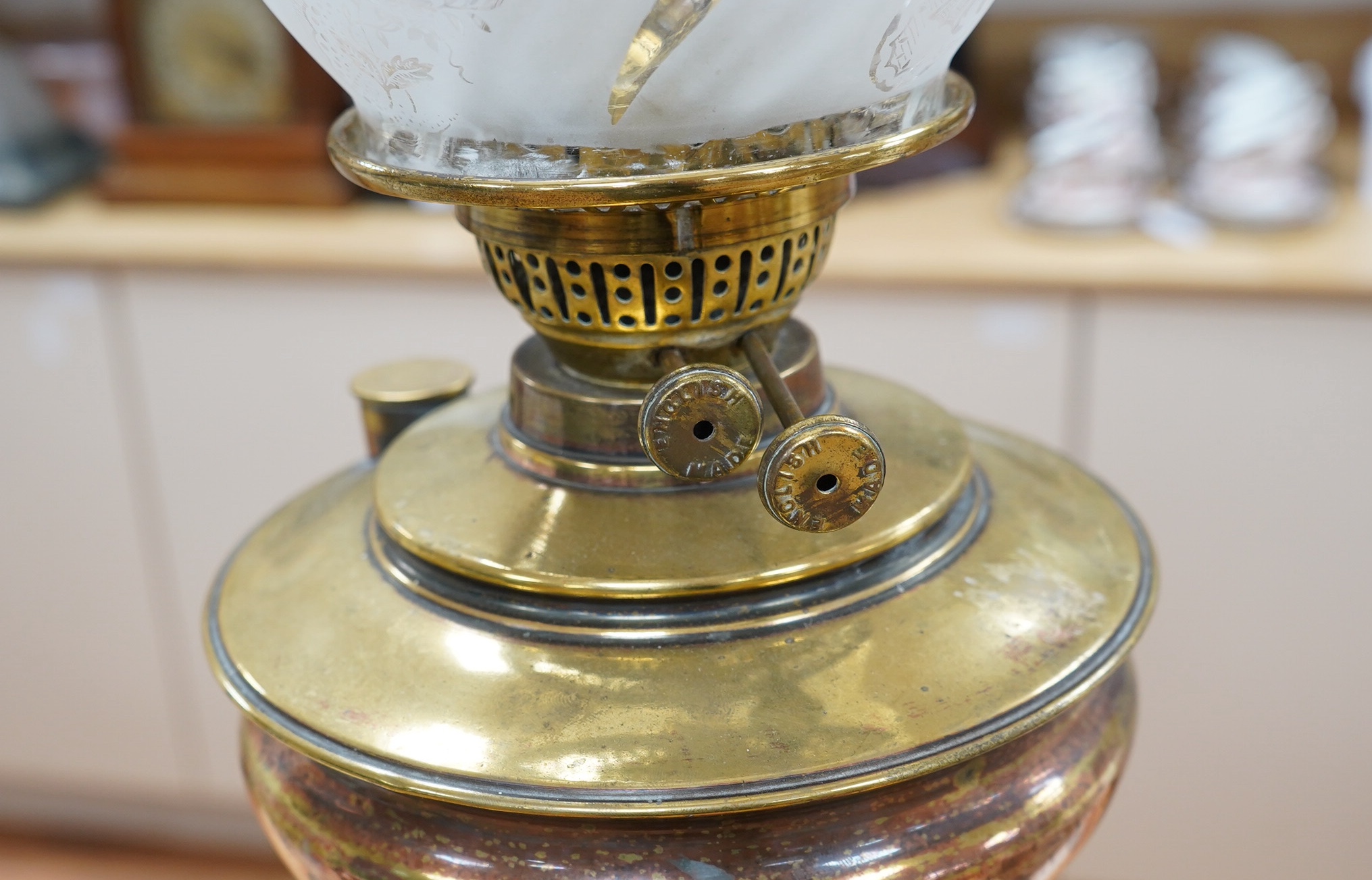 An English Arts and Crafts oil lamp with frosted acid etched shade, chimney, overall 74cm high. Condition – areas of old copper plating showing otherwise in good condition